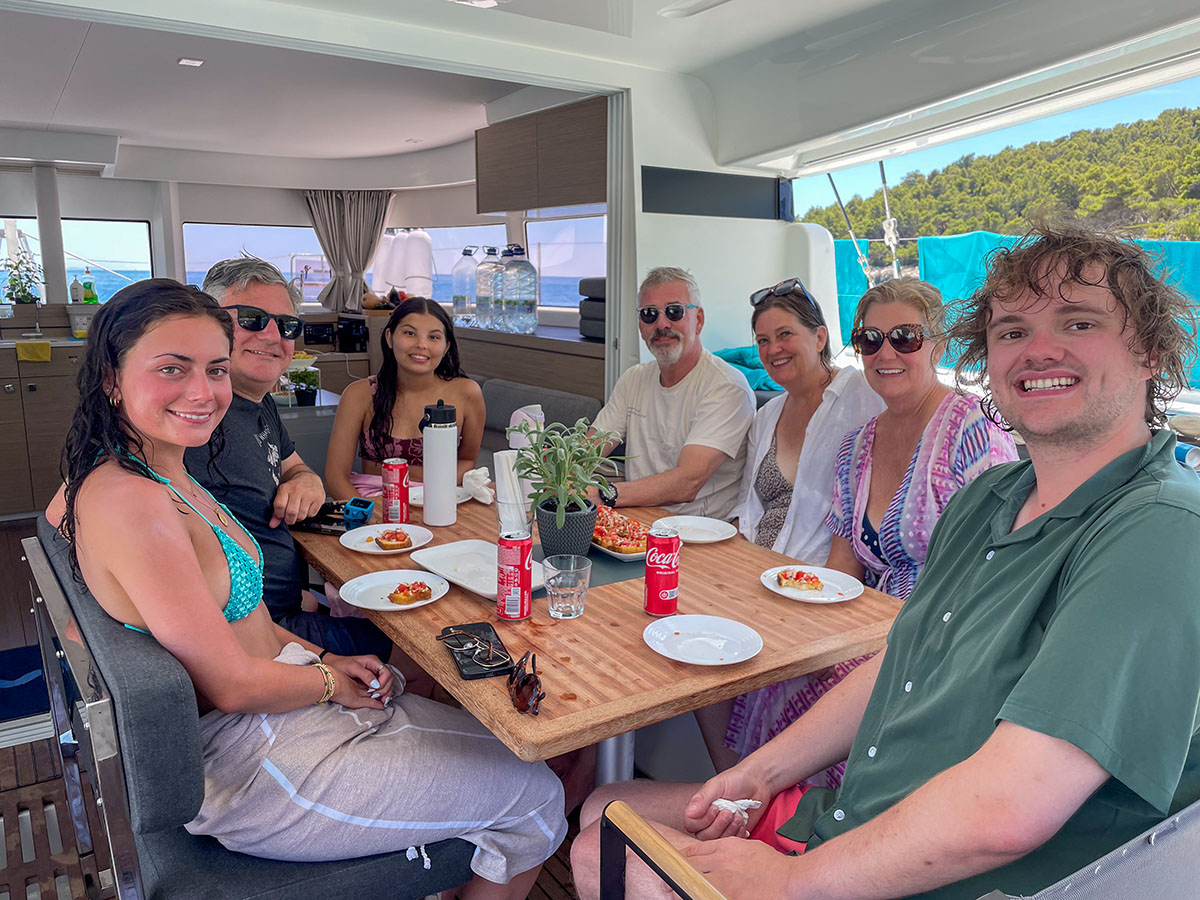 Family enjoying a meal around the shaded cockpit table