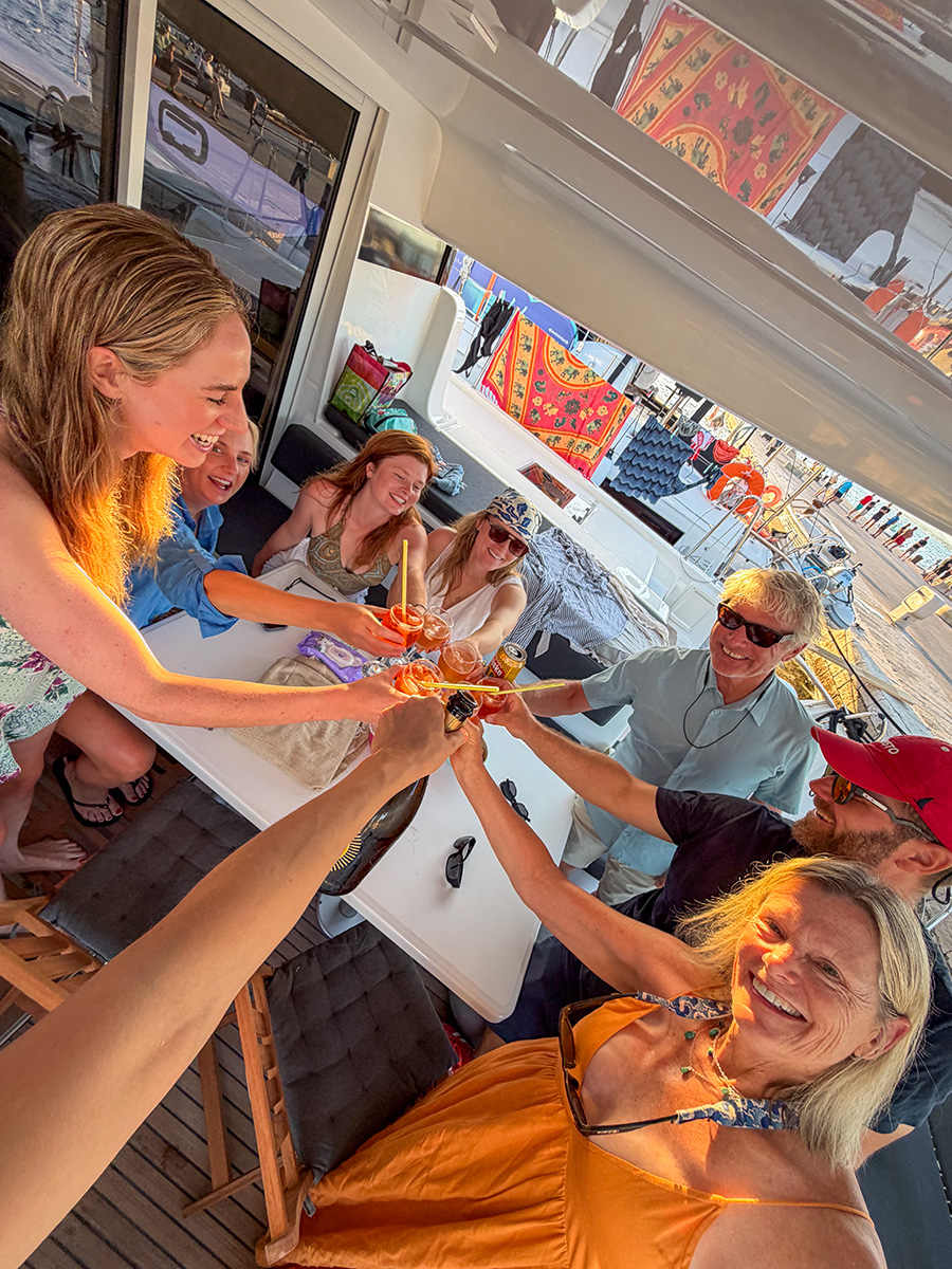 Guests raising cocktails around the cockpit table