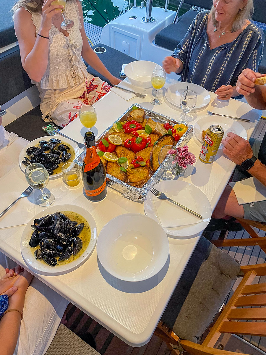 Guests sharing mussels and lunch on board