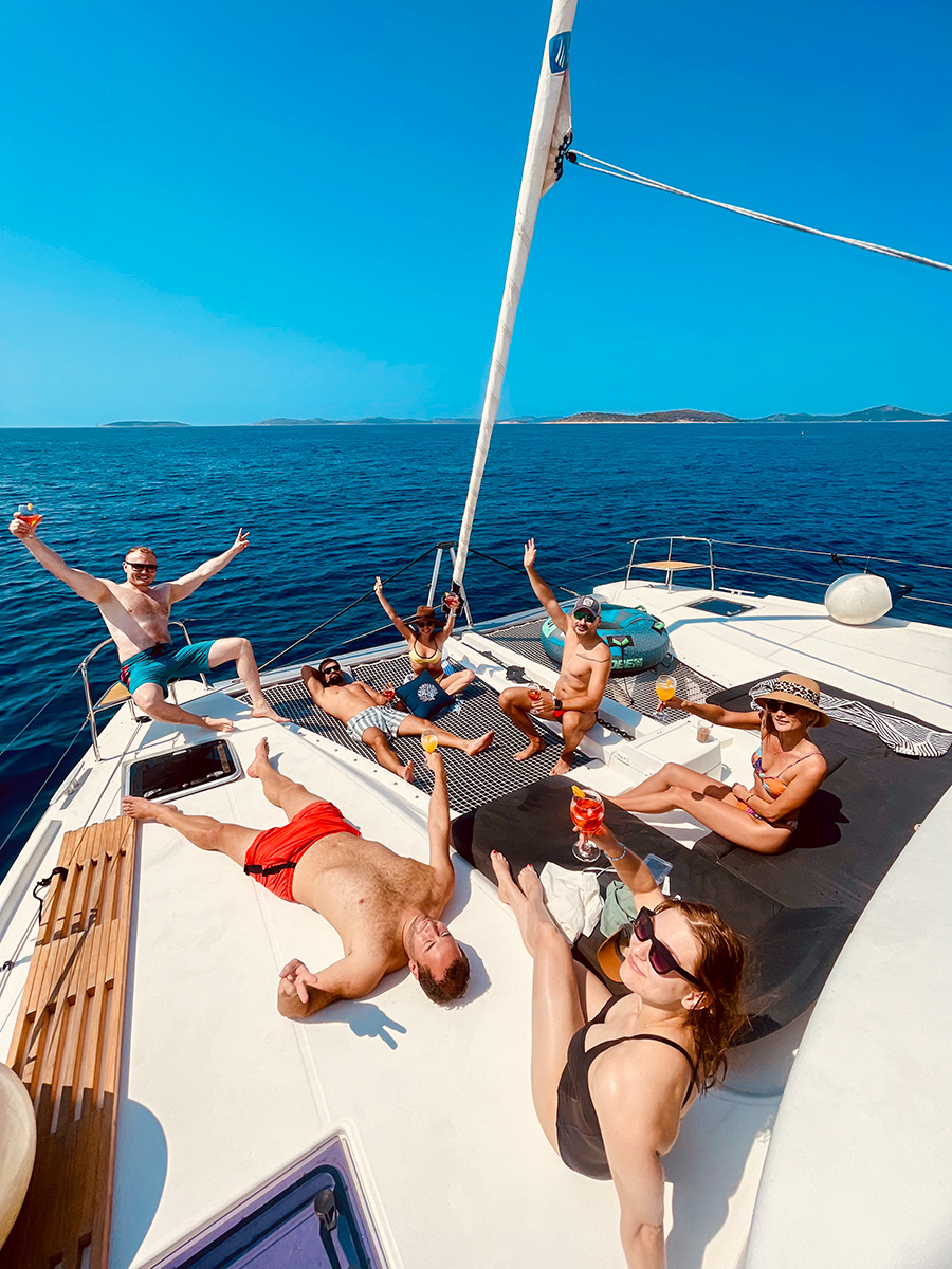 Guests lounging on the forward deck at sea